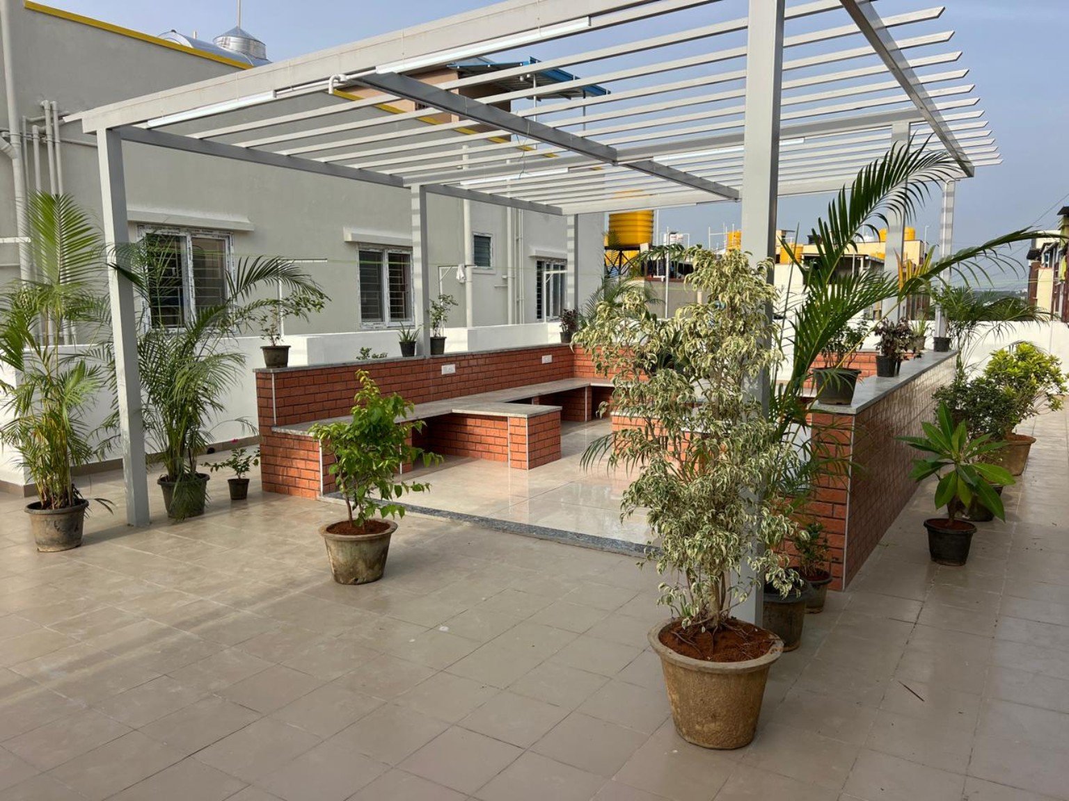 Plant-filled terrace sit-out at VSR Premium Ladies PG